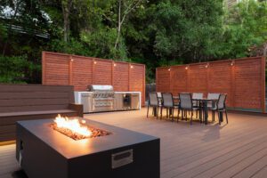 Composite deck with fire pit, dining area and privacy fence