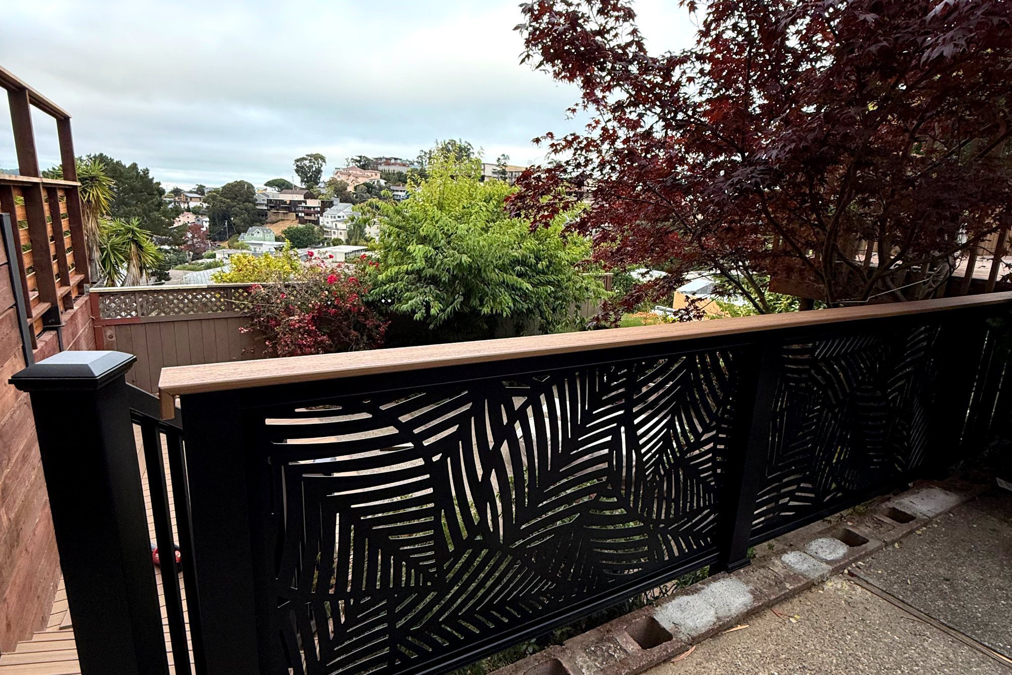 Black aluminum railing with decorative panel in Brisbane, CA