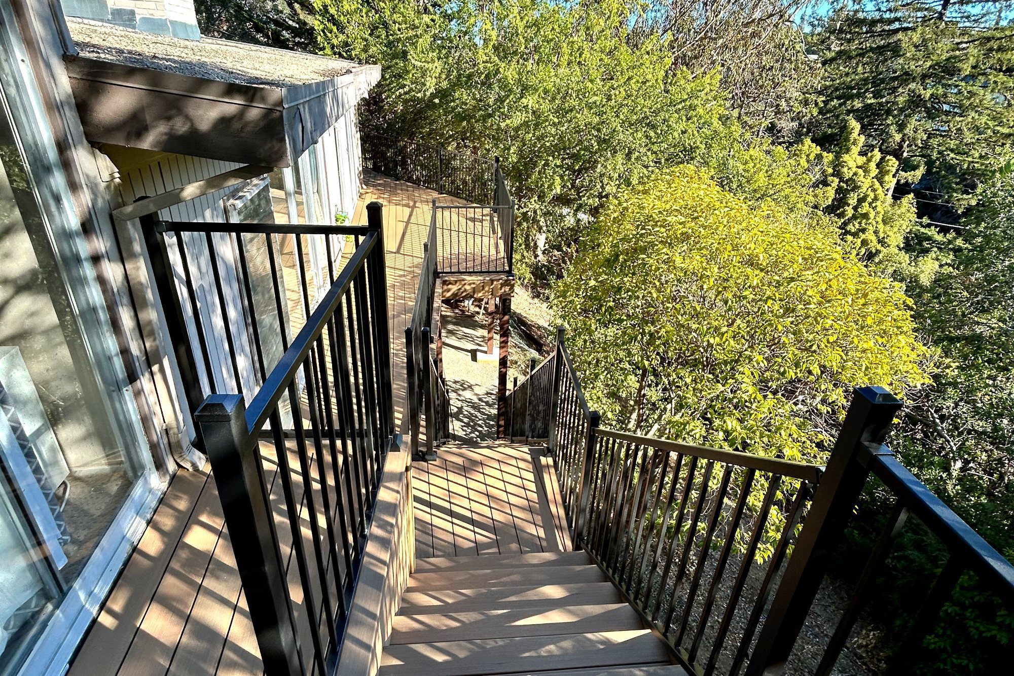 Long composite deck with railing in Burlingame, CA