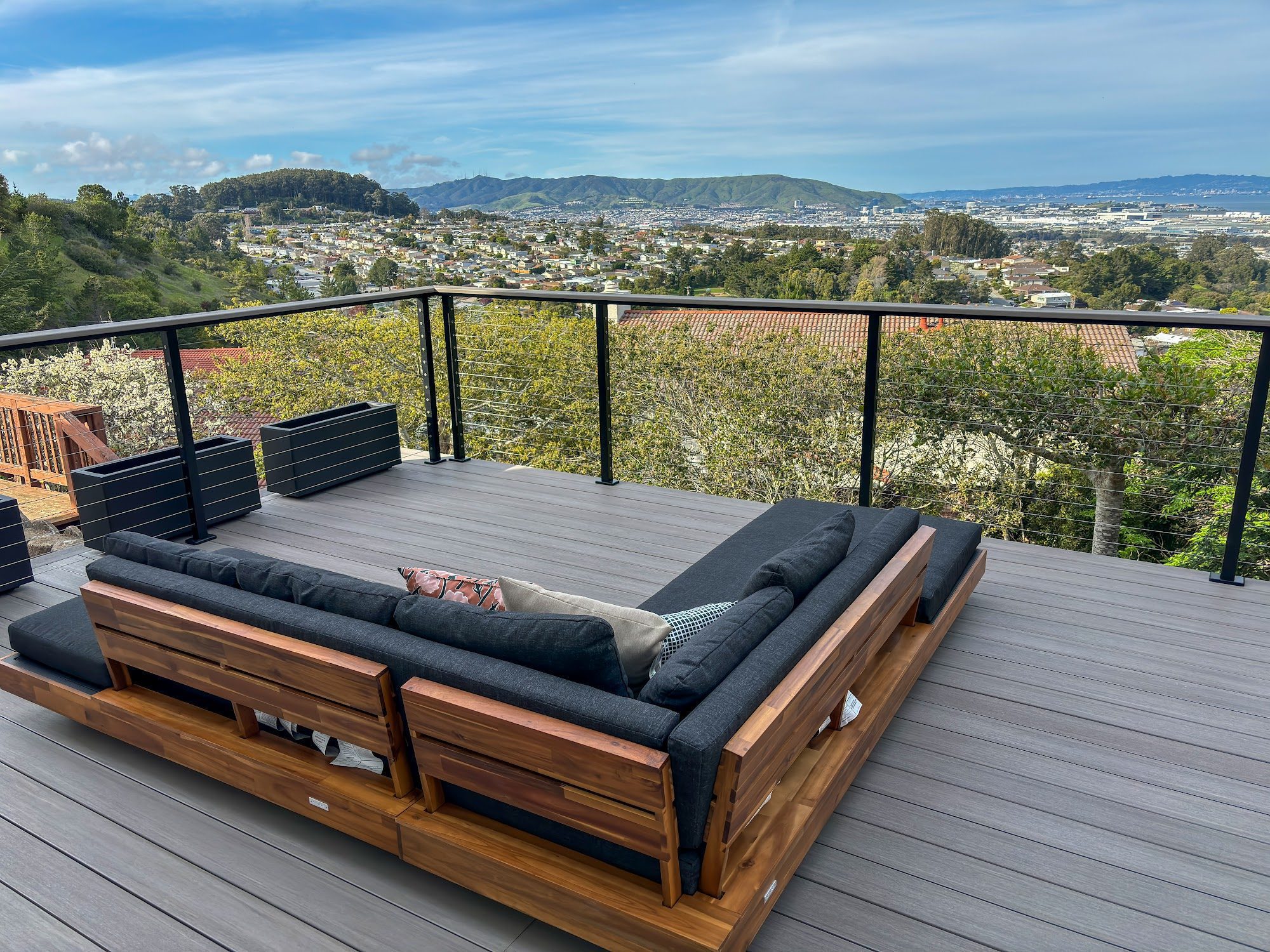 Lounge seating on a composite deck with cable railing in Millbrae, CA