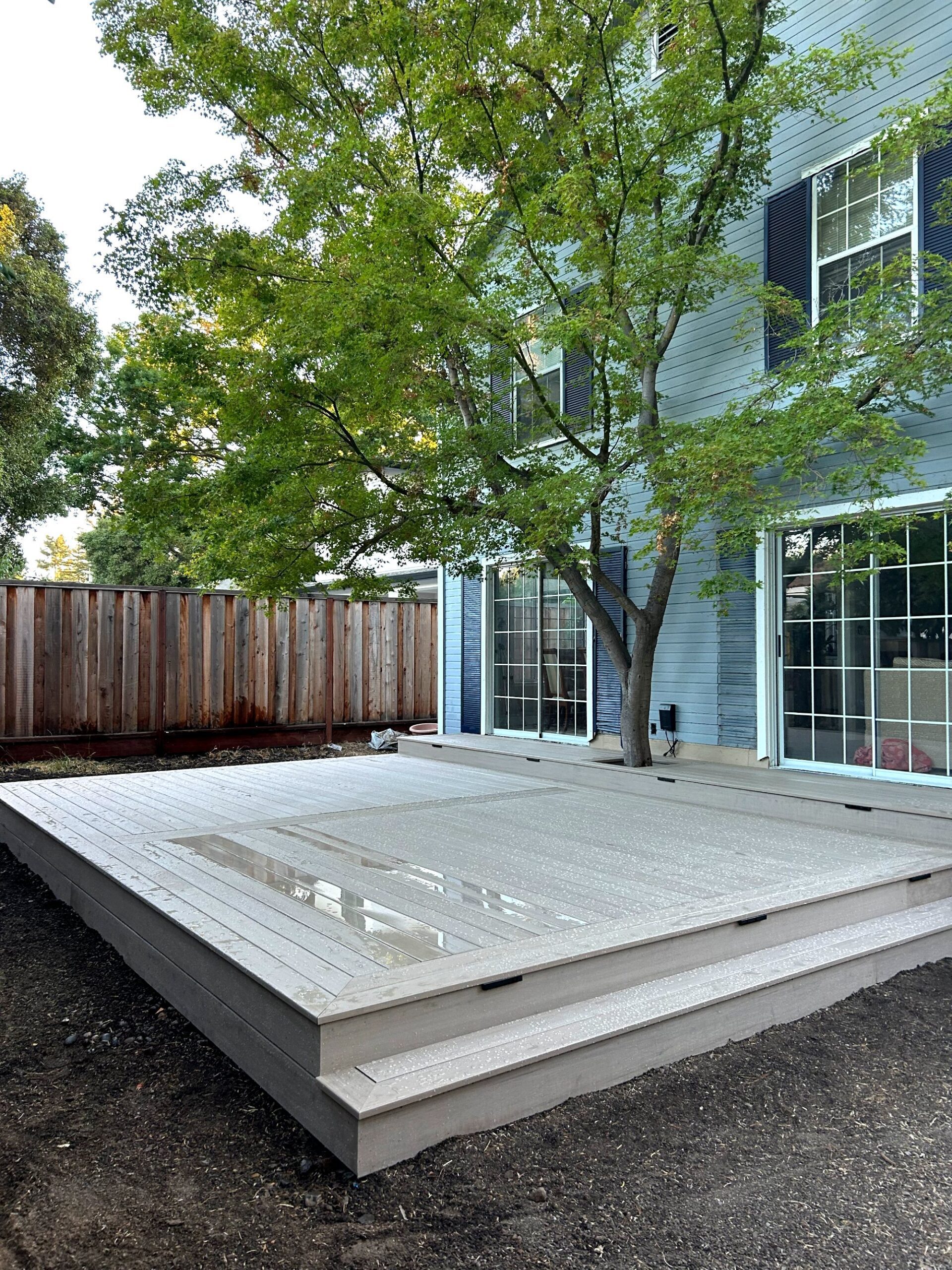 Low composite deck with a framed border in Palo Alto, CA