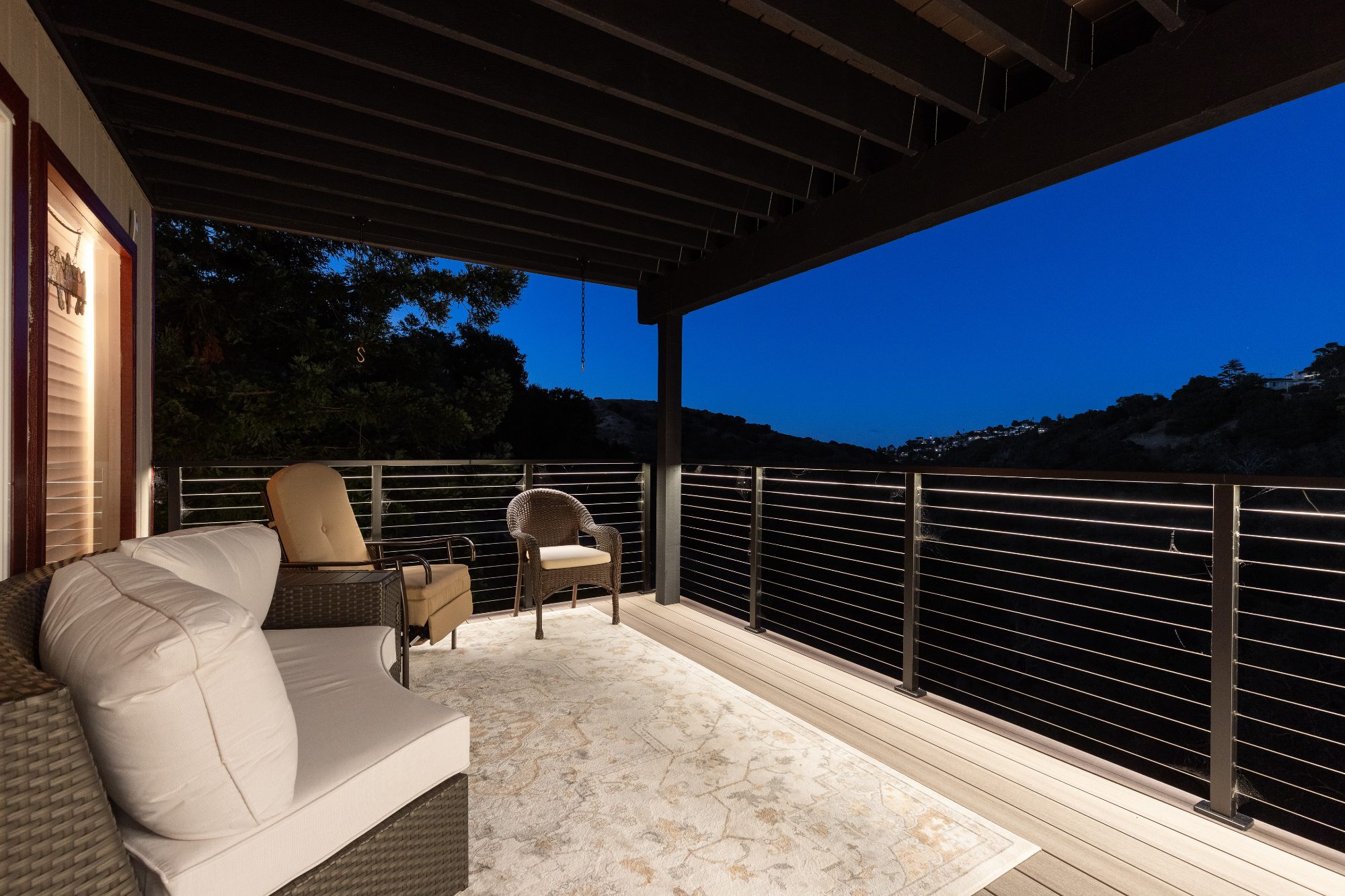 Covered deck with cable railing and outdoor seating in Belmont, CA