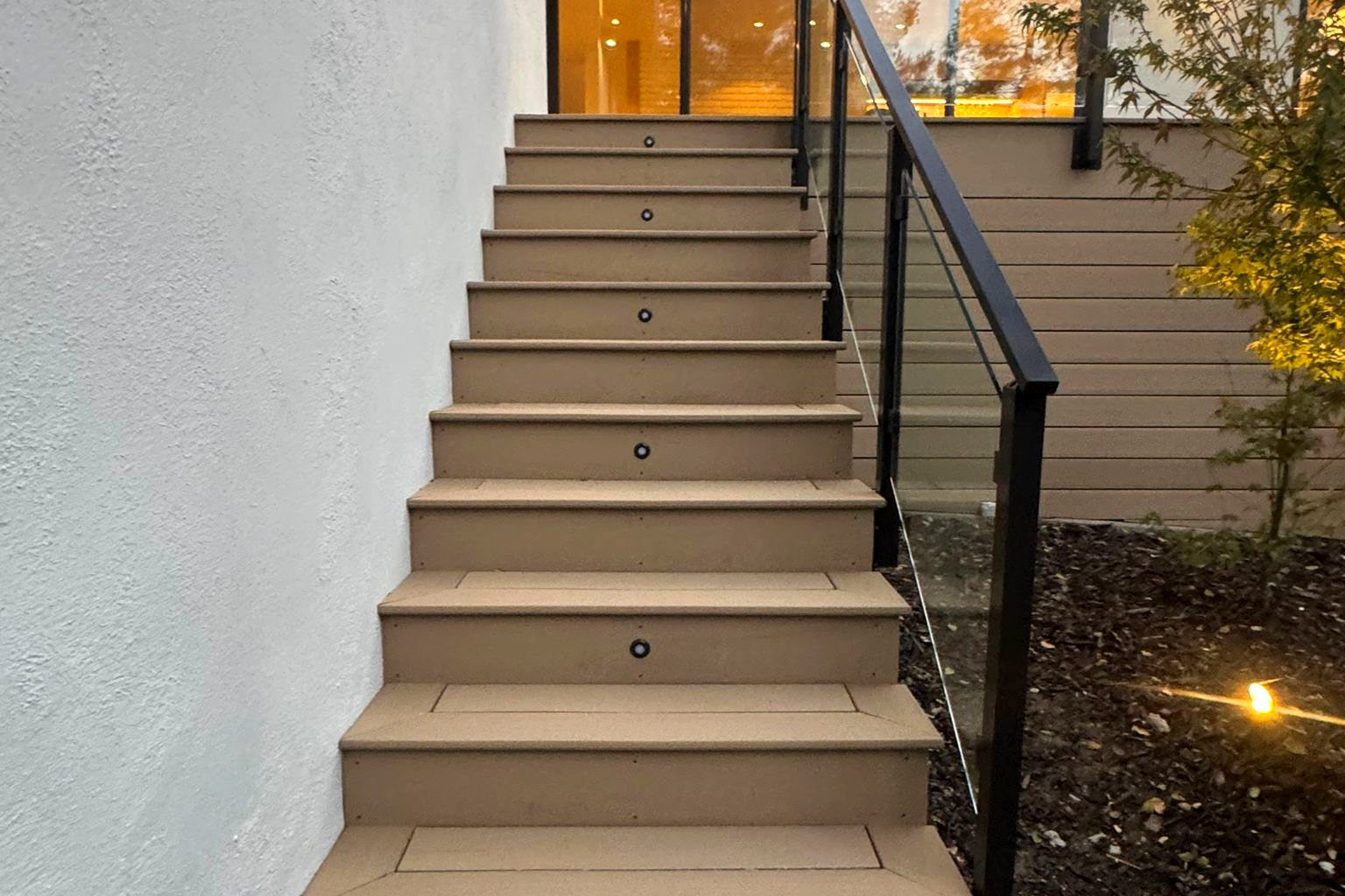 Composite deck stairs with glass railing in Hillsborough, CA