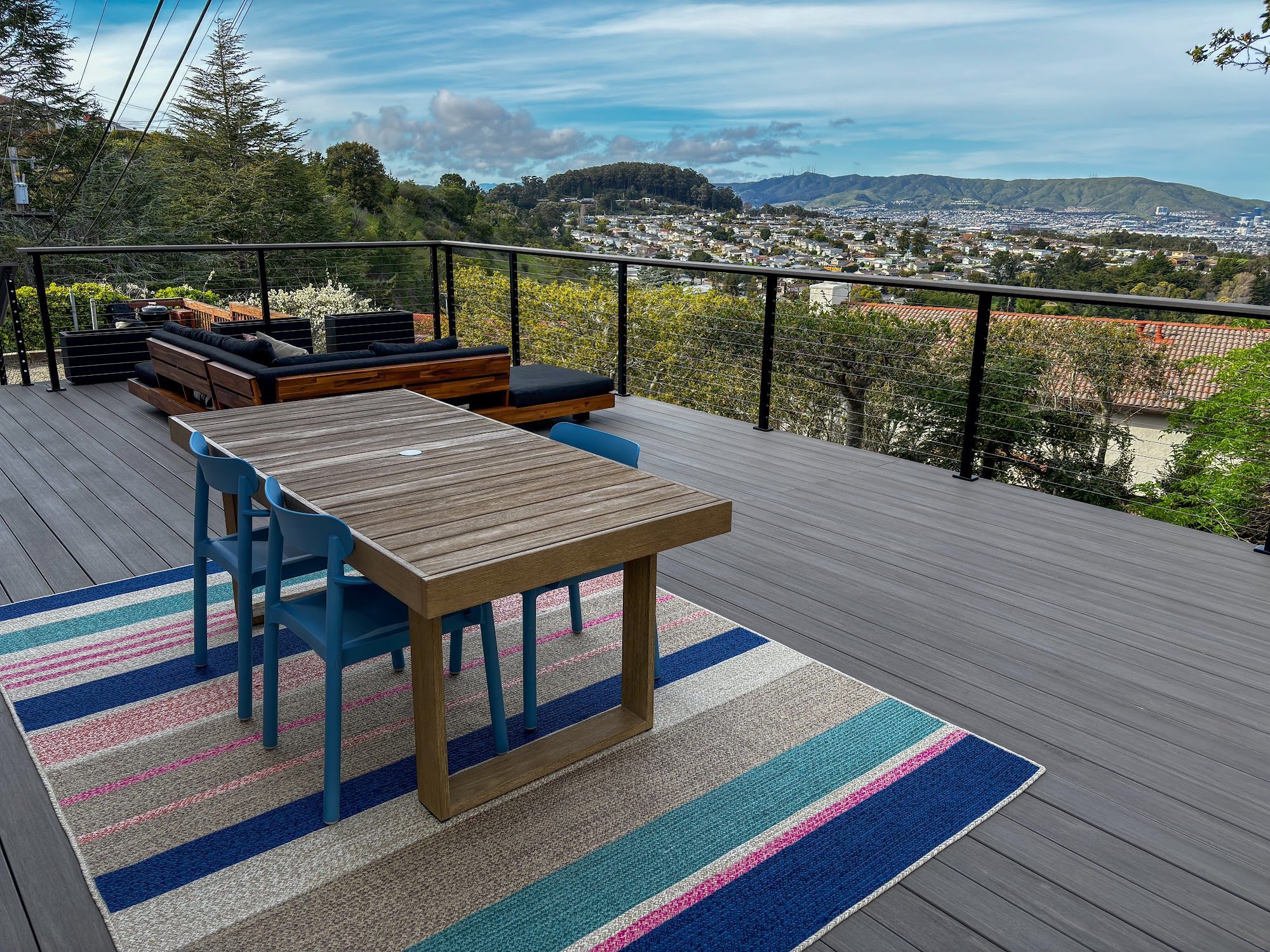 Outdoor dining area on a raised deck with a view in Millbrae, CA