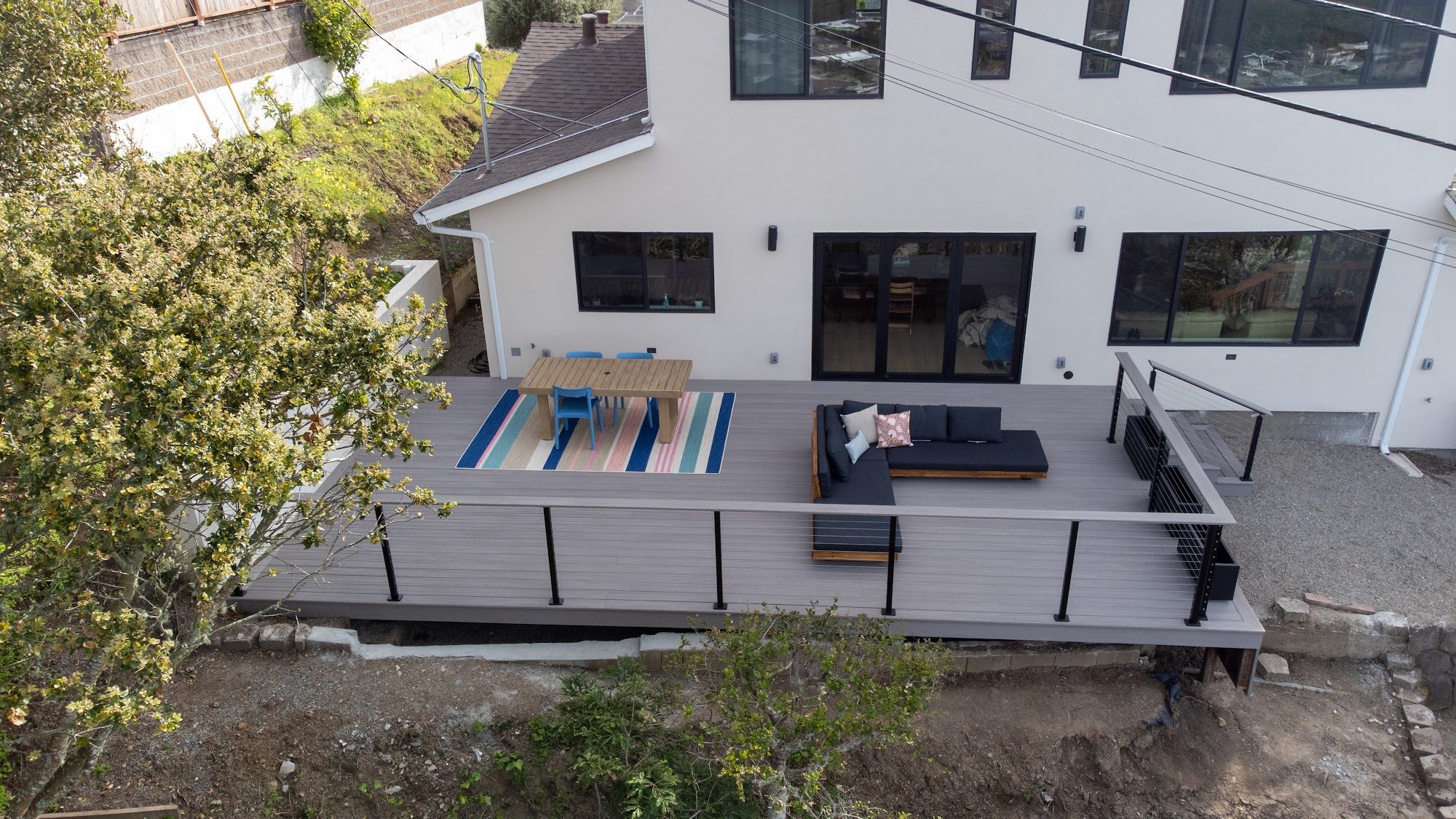 Elevated composite deck with lounge area in Millbrae, CA