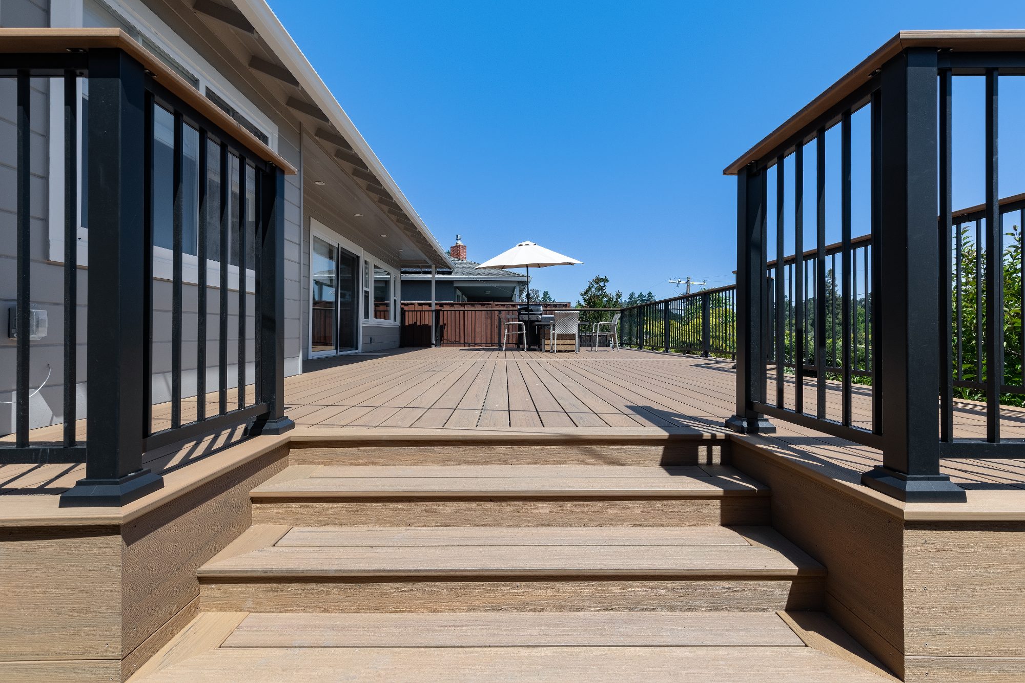 Composite deck steps and black aluminum railing in San Carlos, CA