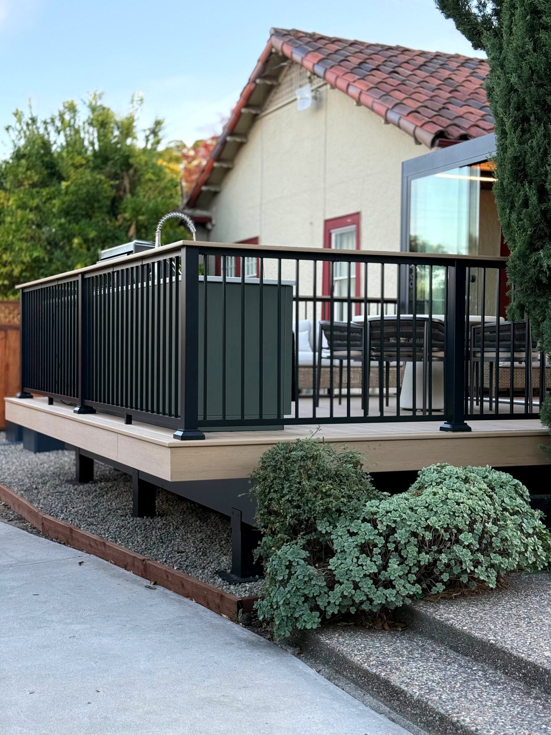 Raised composite deck with black aluminum railing in Santa Clara, CA